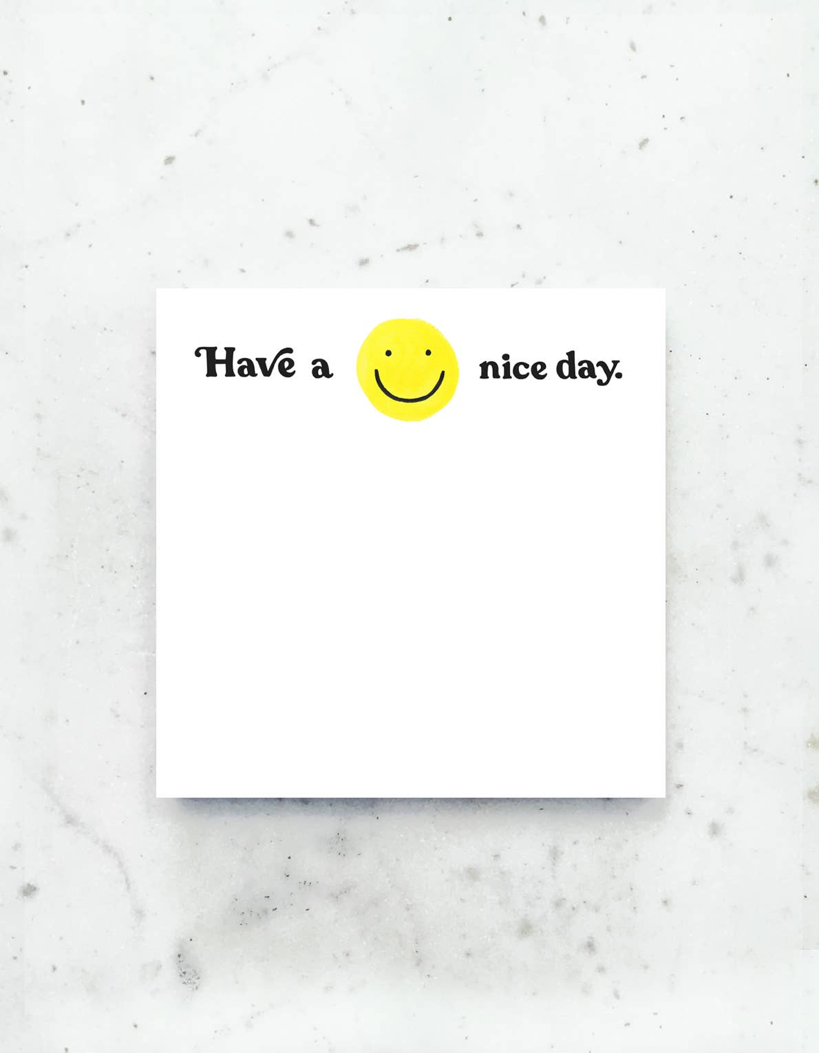 A jumbo desk pad with a cheerful yellow smiley face and the message “Have a nice day” written in bold, playful lettering.