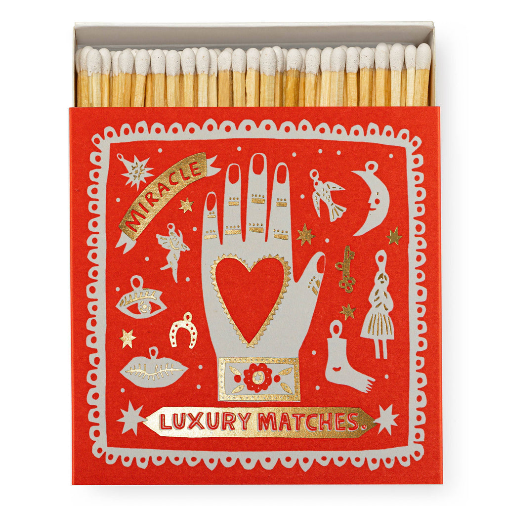 A square matchbox labeled "Miracle Luxury Matches" with an elegant design.