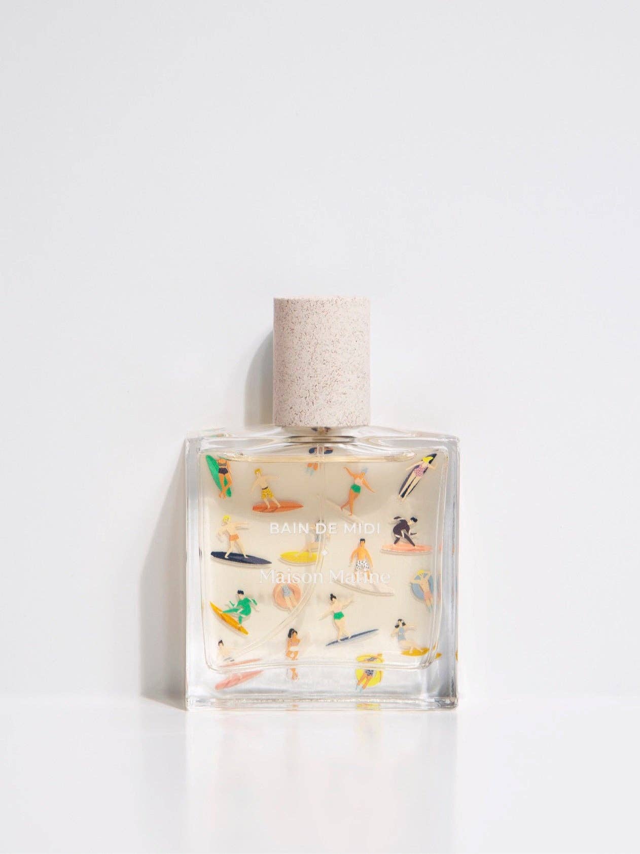 Maison Matine Bain de Midi perfume bottle with playful illustrations and white cap, styled with flowers and modern props.