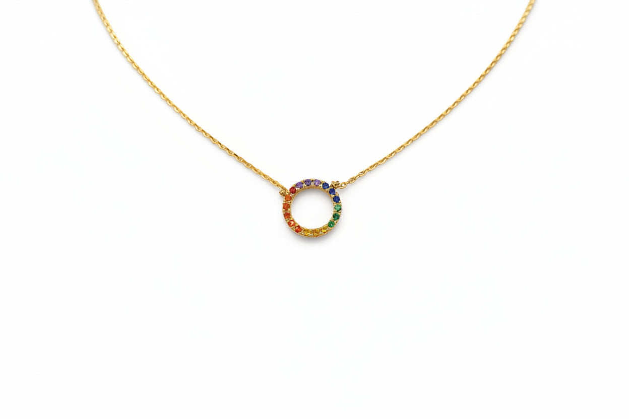 Gold necklace with a colorful circular pendant on a white background