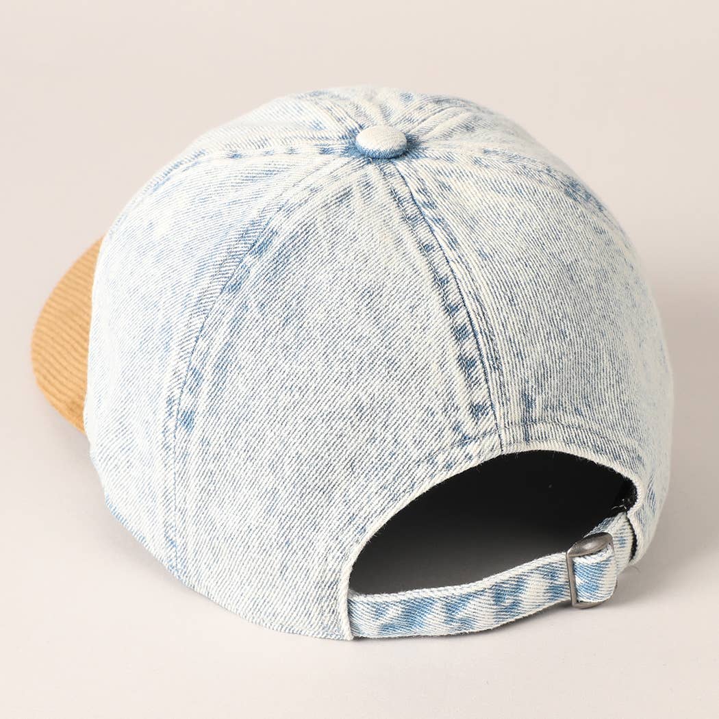 Denim cap with a beige visor on a light background