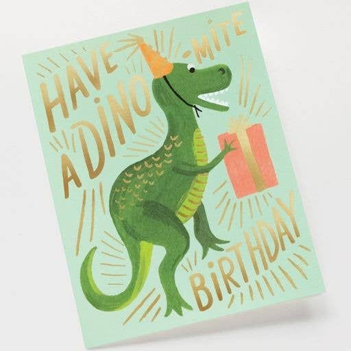 A birthday card featuring a green dinosaur wearing a party hat and holding a gift, with the text "Have a Dino-Mite Birthday," paired with a gold envelope.