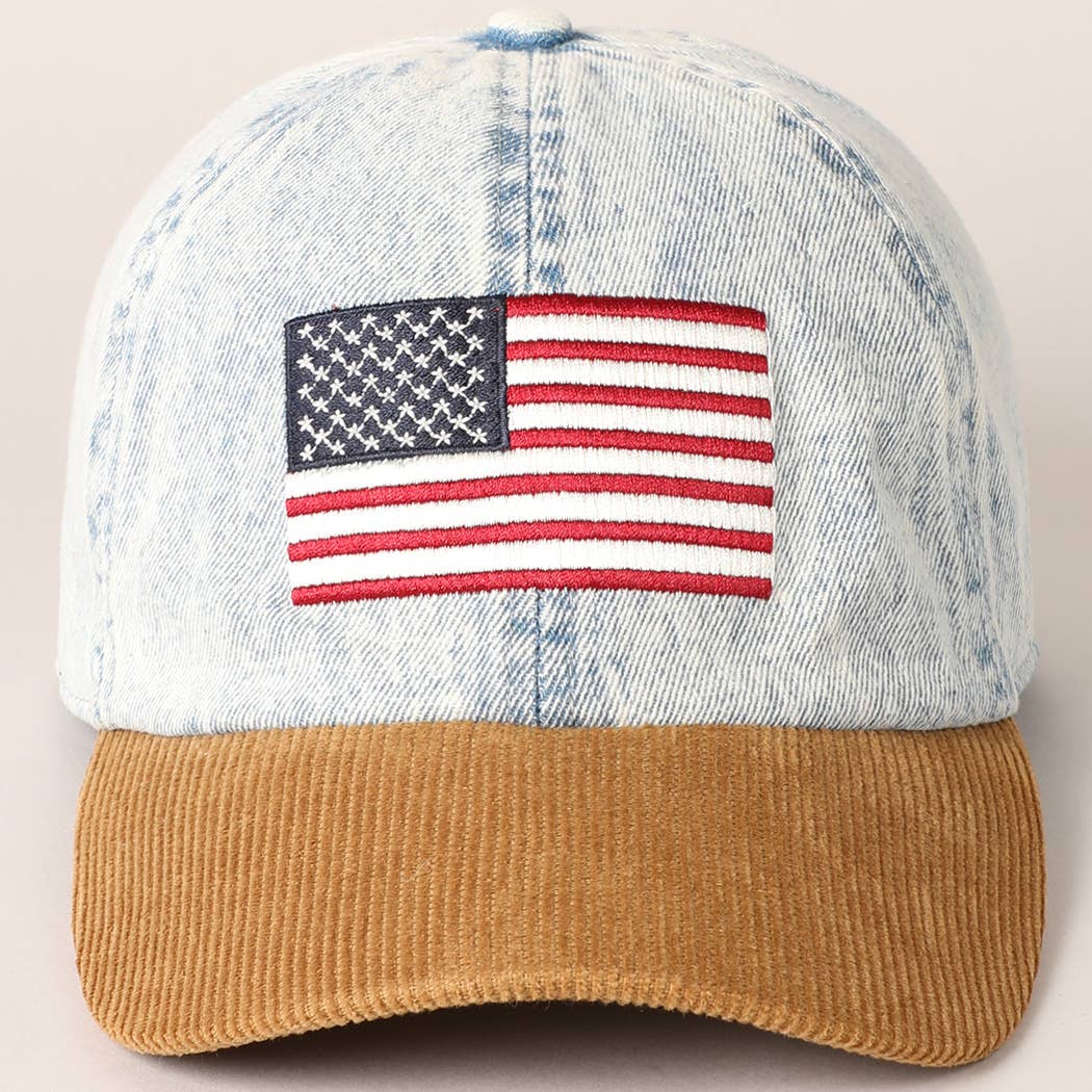 Denim cap with American flag patch and brown brim on a light background