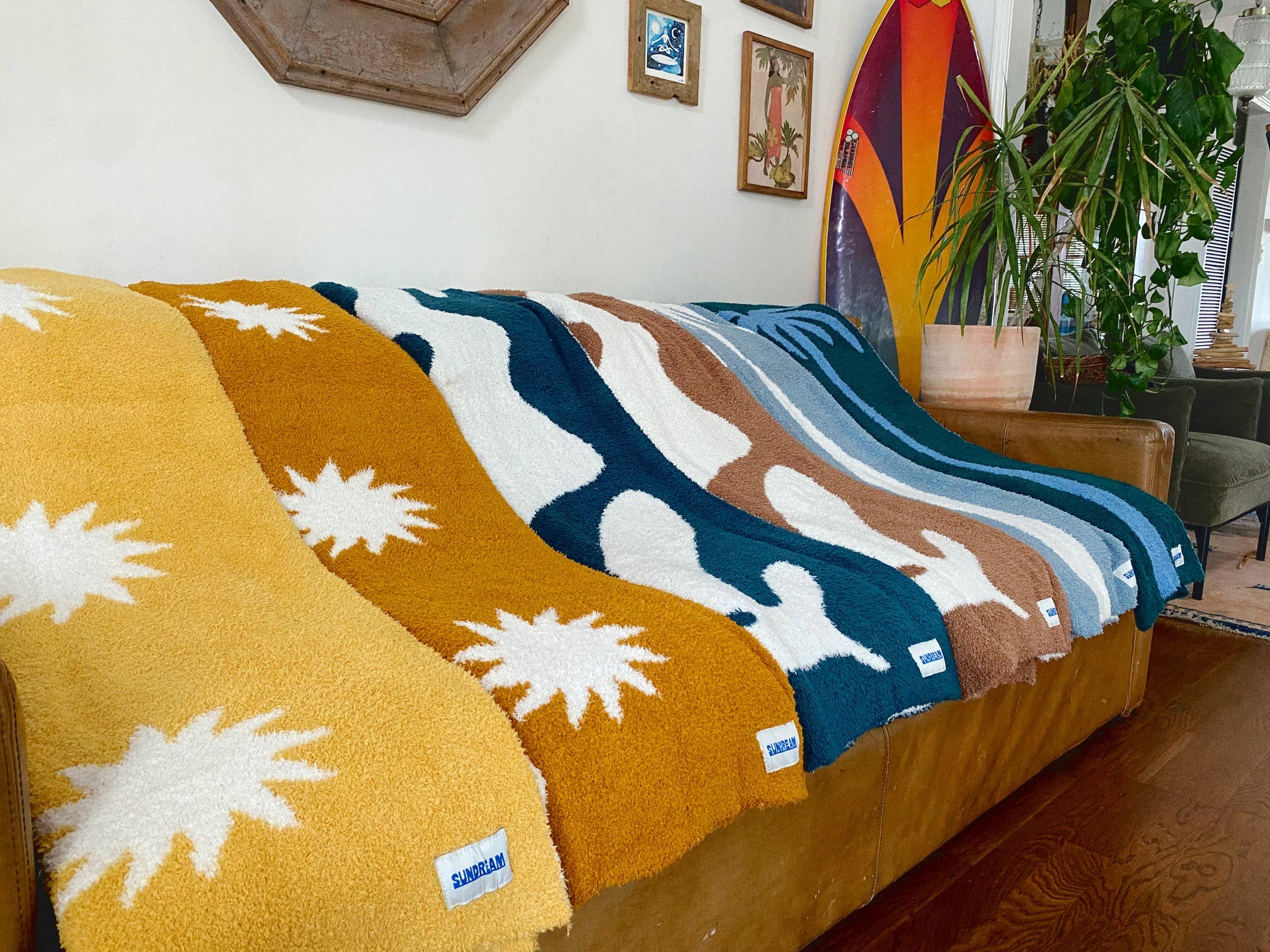 Soft brown plush throw blanket with a sun and palm tree design, perfect for adding warmth and a stylish accent to any space.