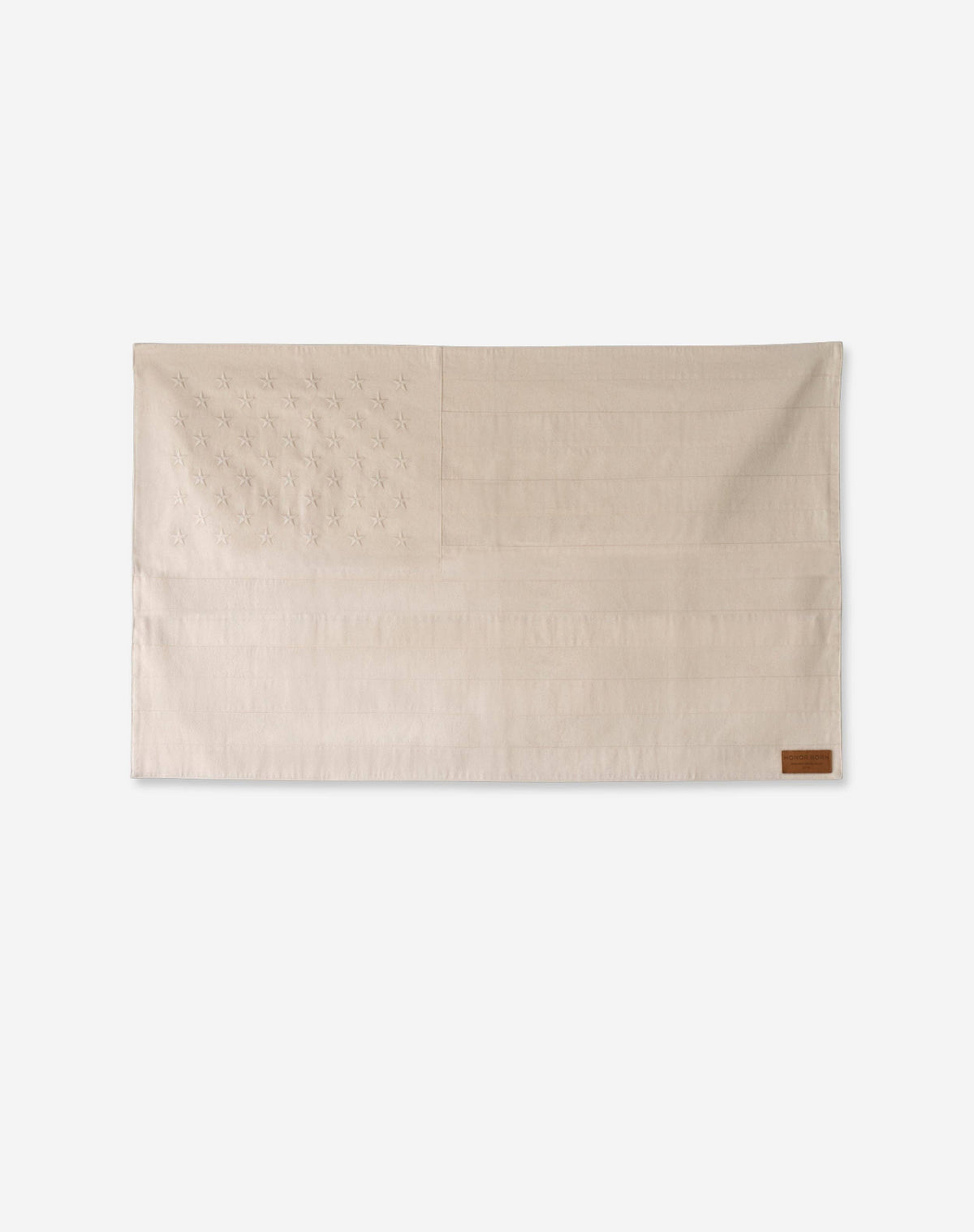 Beige blanket with a brown label on a white background