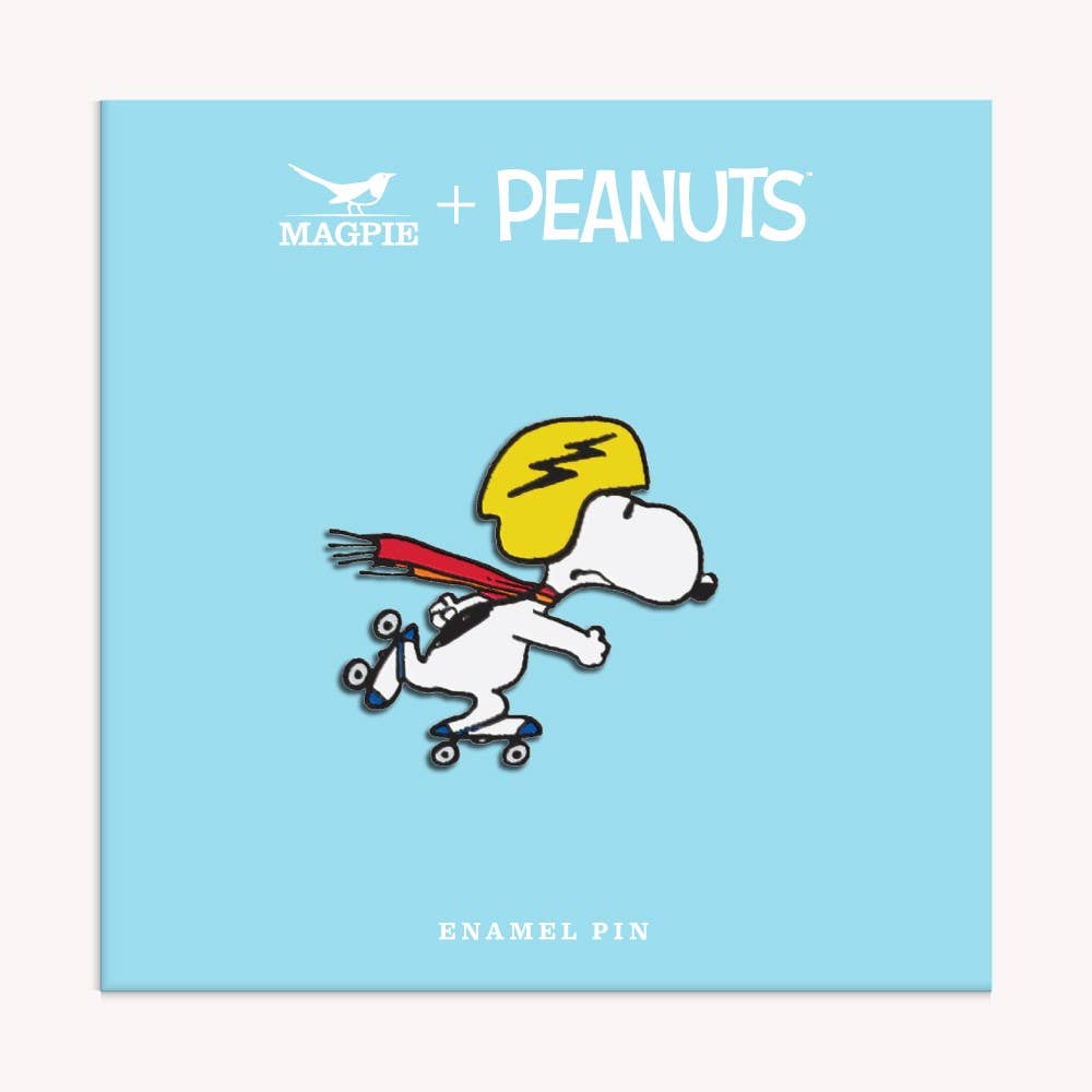 Snoopy enamel pin featuring Snoopy on a skateboard, wearing a red scarf and yellow helmet.