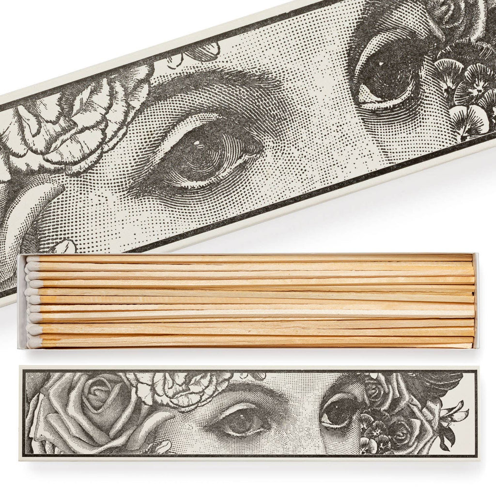 A long matchbox adorned with wide-eyed motifs.