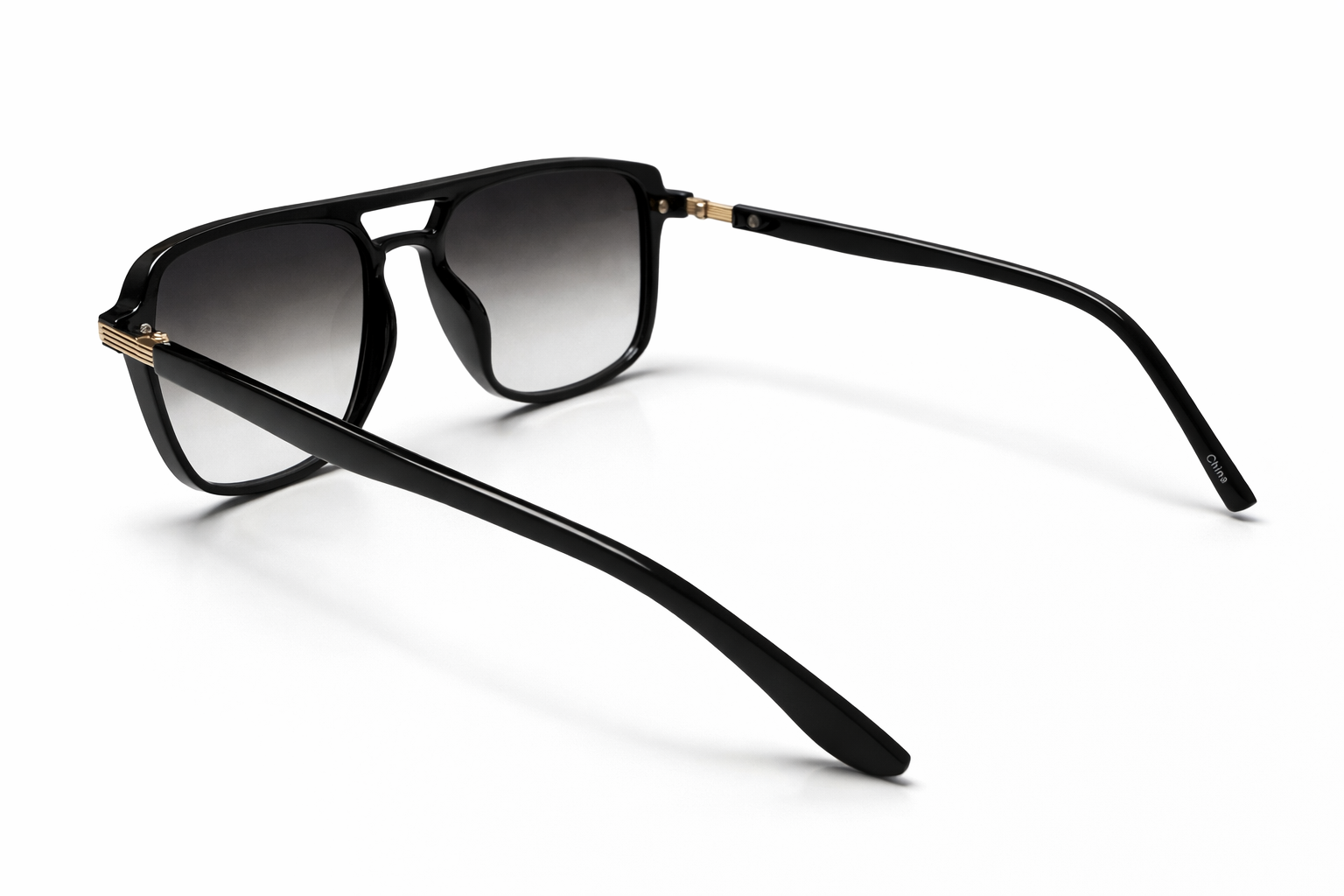 Black sunglasses with gradient lenses on a white background