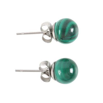 Hand holding a pair of malachite crystal stud earrings on a matching backing card with the text “Promotes Confidence.”
