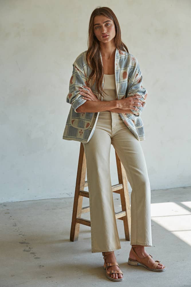 Quilted cotton jacket with desert-themed motifs and soft blue, cream, and terracotta tones