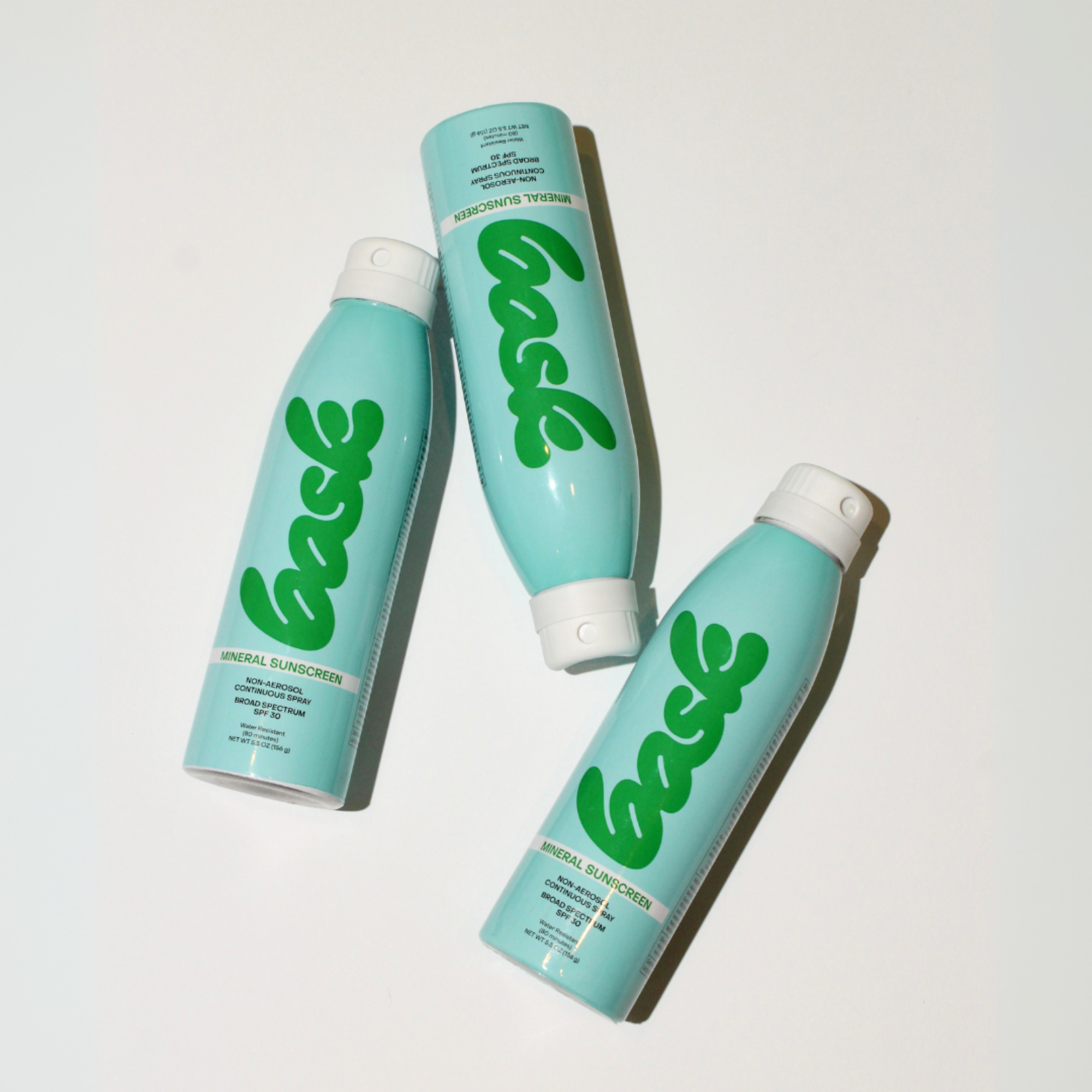 A bottle of Bask SPF 30 Mineral Non-Aerosol Spray with a turquoise label on a white background.