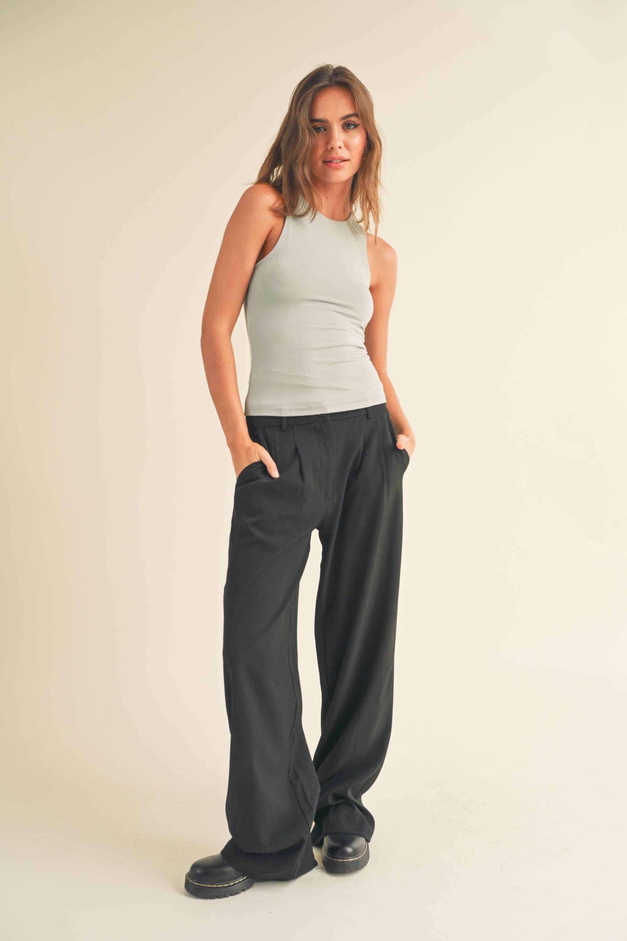 Woman wearing fitted sleeveless Lena Tank Top in neutral tones
