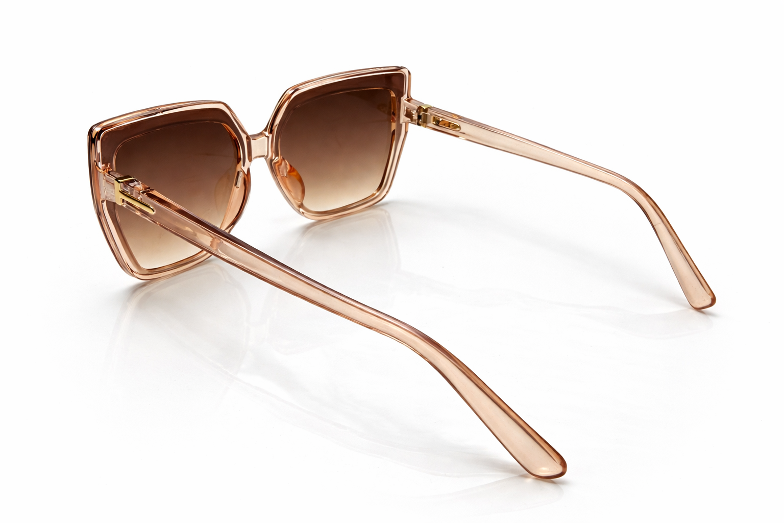 Rose gold sunglasses with brown gradient lenses on a white background