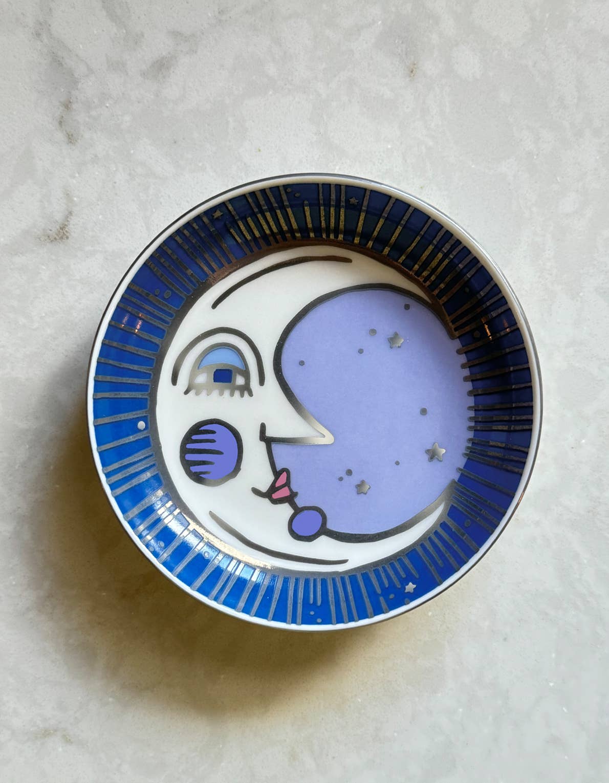Moon trinket dish with a whimsical moon design in blue and purple accents, perfect for holding small items.