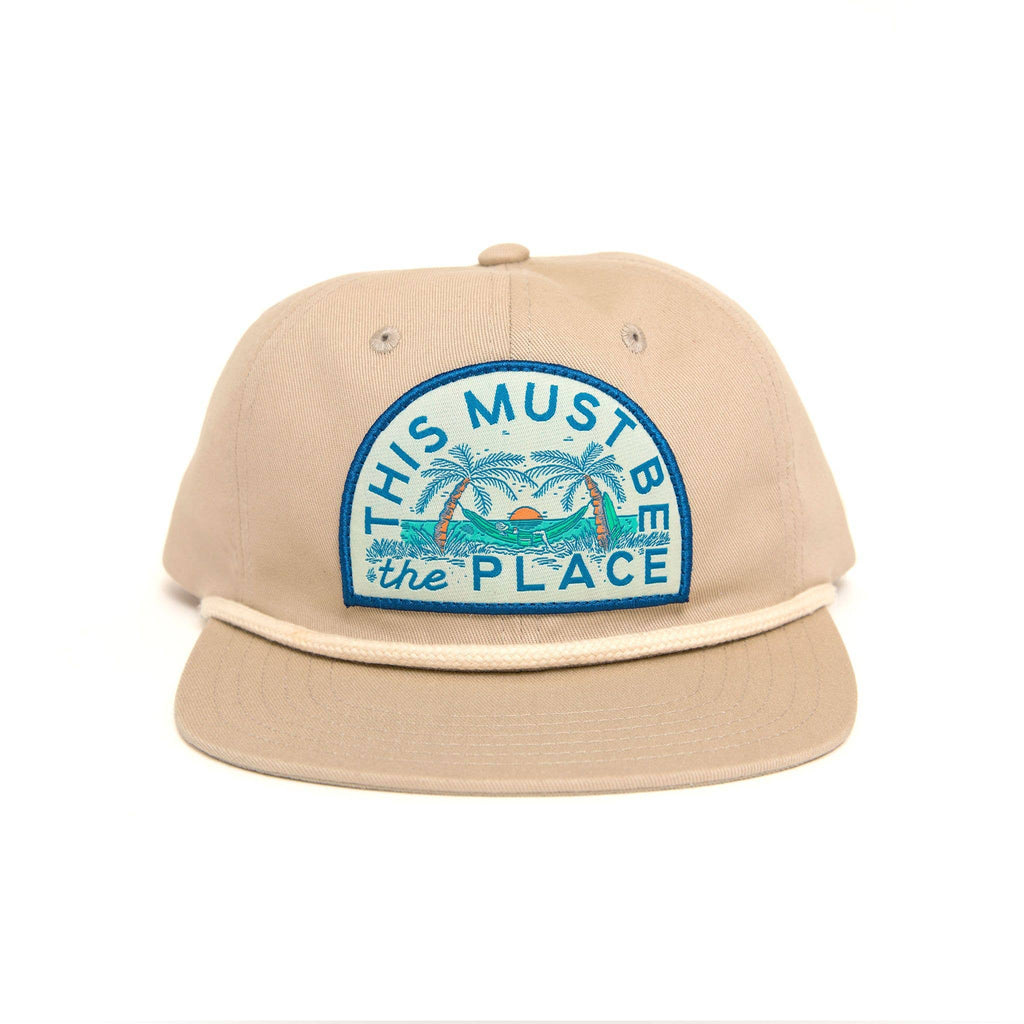 This Must Be The Place Hat - Beach: Classic baseball cap with embroidered beach-inspired slogan, epitome of coastal charm and style.