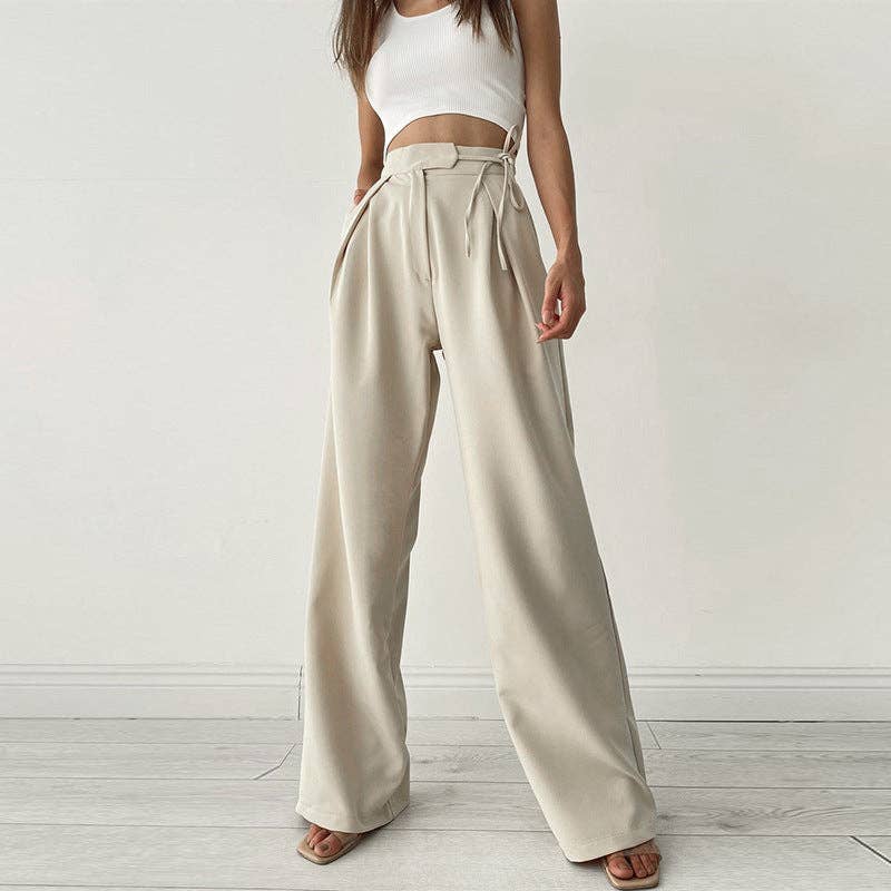 Woman wearing Urban Elegance Palazzo Pants in cream color with a white crop top.