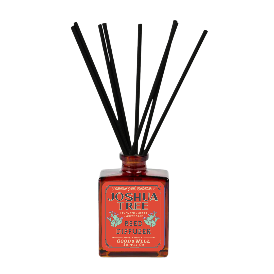 Joshua Tree reed diffuser with amber glass bottle and black reeds by Good & Well Supply Co., scented with lavender, cedar, and sage.