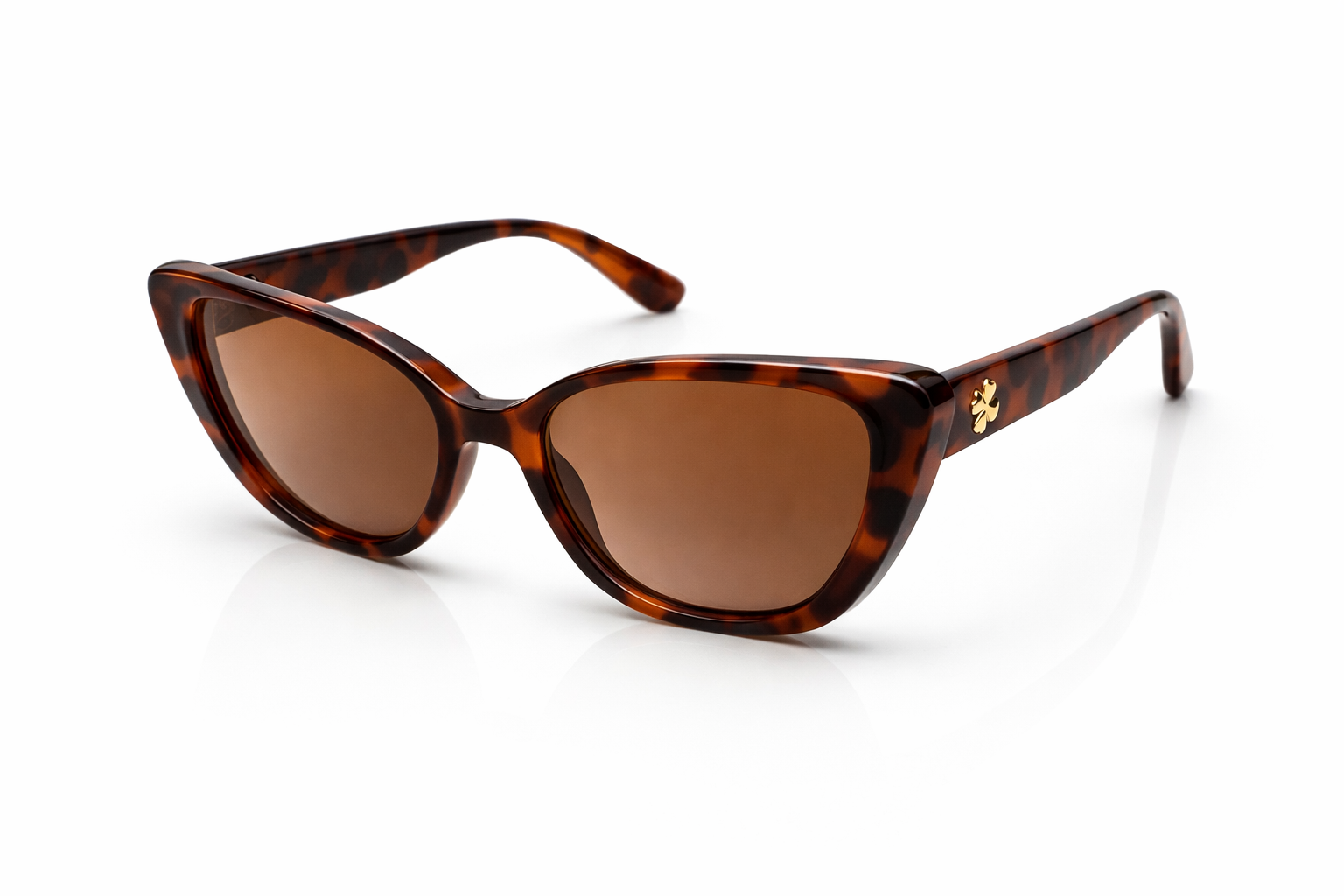 Tortoiseshell sunglasses with brown lenses on a white background
