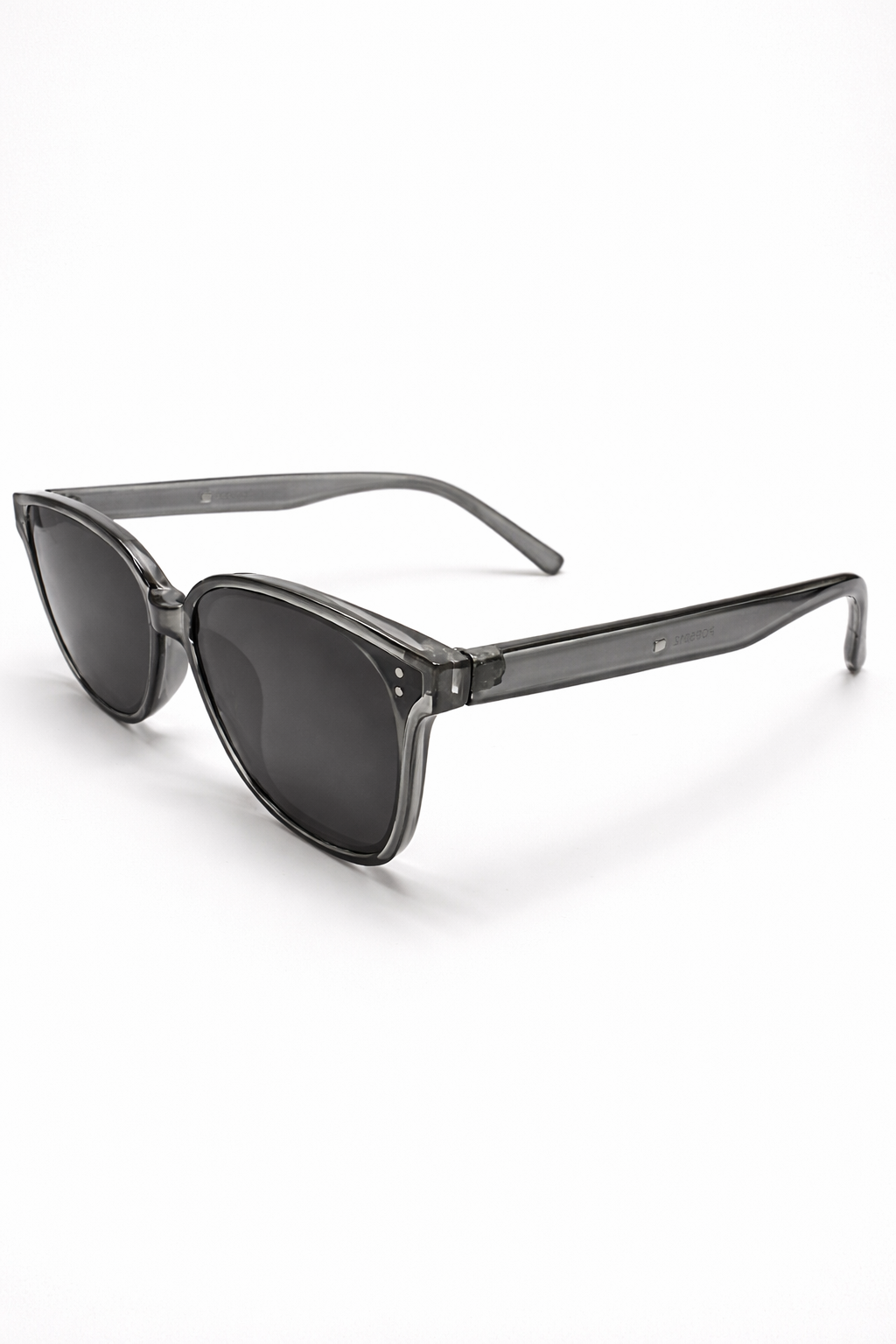 Black sunglasses with a visible Chanel logo on a white background