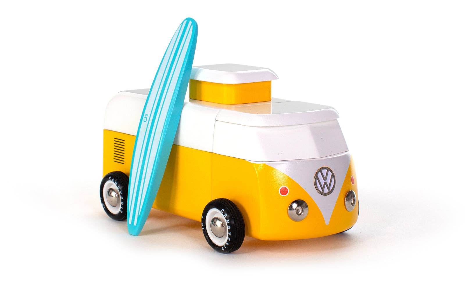 Toy Volkswagen camper van with a surfboard on a white background