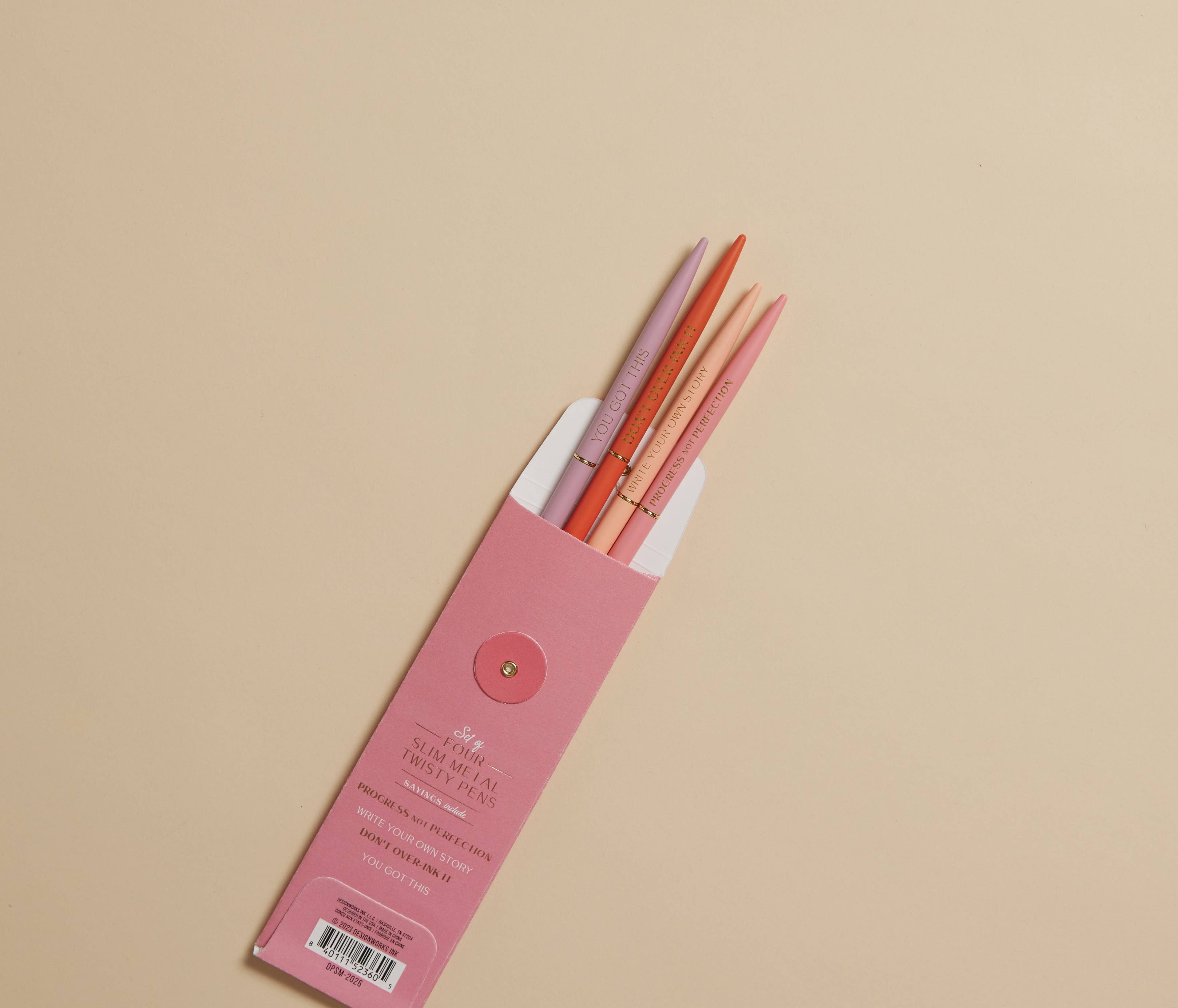 Pink pencil case with orange pencils on a beige background
