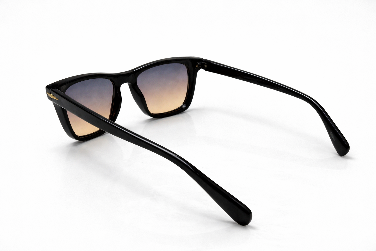Black sunglasses with gradient lenses on a white background
