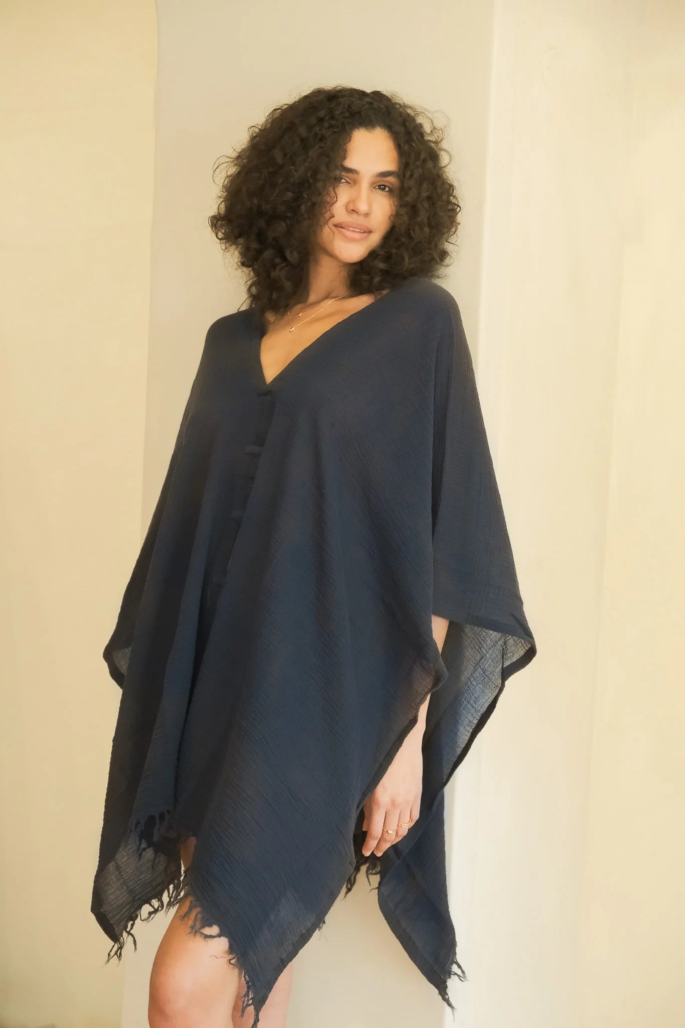 A woman gracefully wearing the Ava Kimono, showcasing its flowing silhouette, delicate patterns, and high-quality fabric.