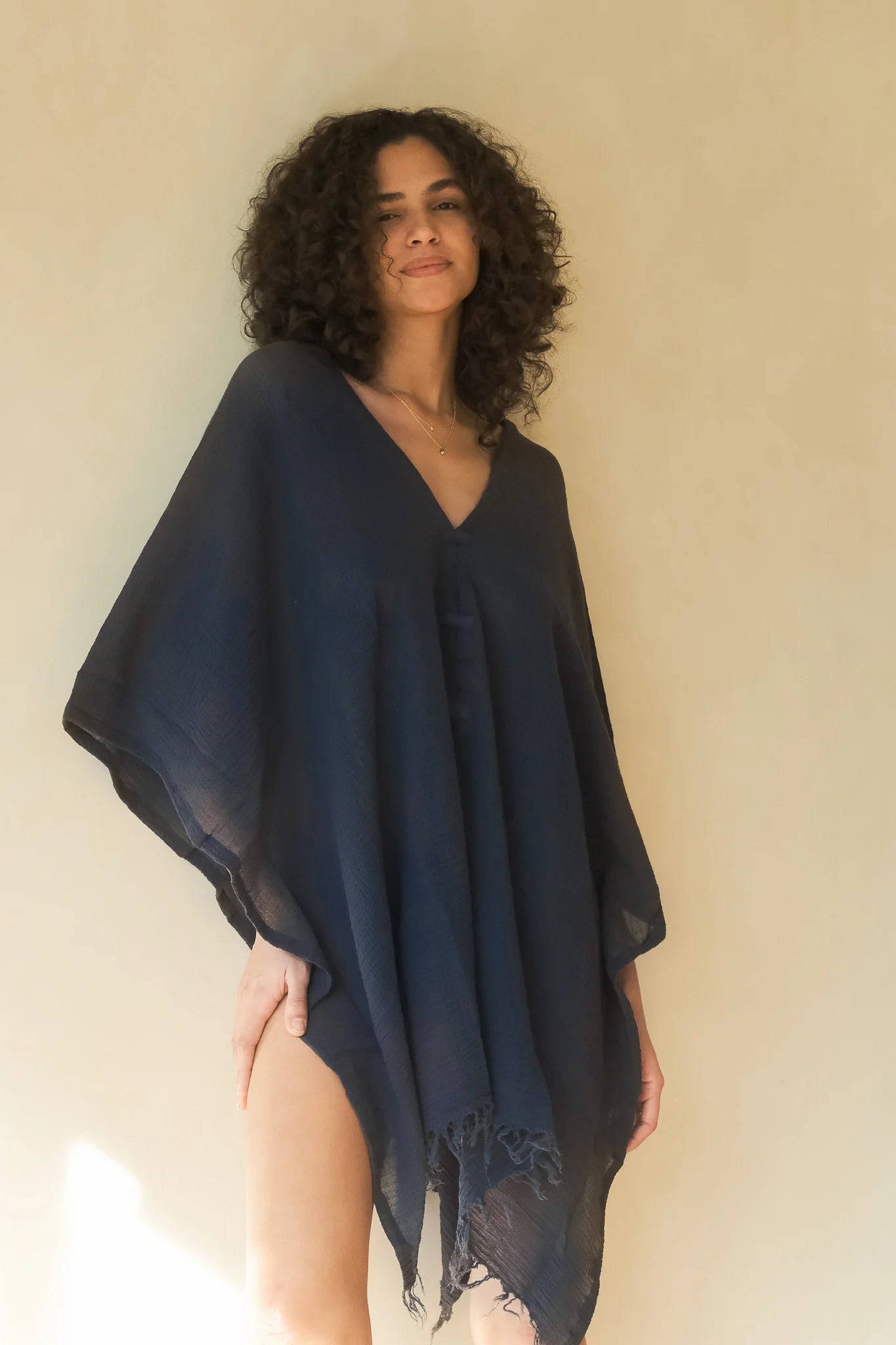 A woman gracefully wearing the Ava Kimono, showcasing its flowing silhouette, delicate patterns, and high-quality fabric.