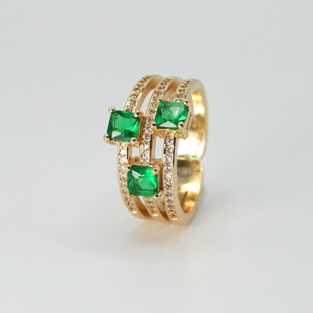 Forest Ring: Wide design adorned with shimmering green stones, epitome of natural beauty.