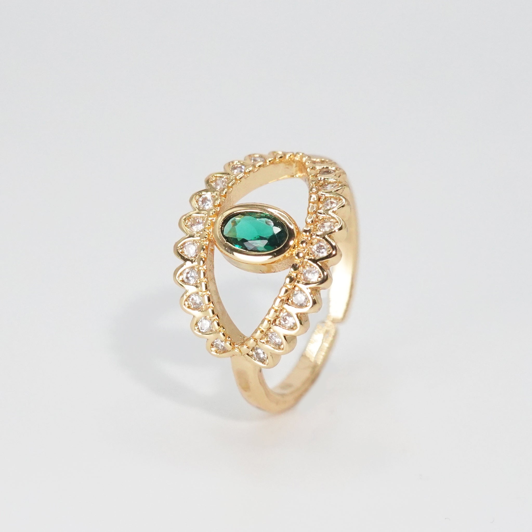 Glenneyre Ring: Eye-shaped design with shimmering stones and a striking green centerpiece, epitome of allure.