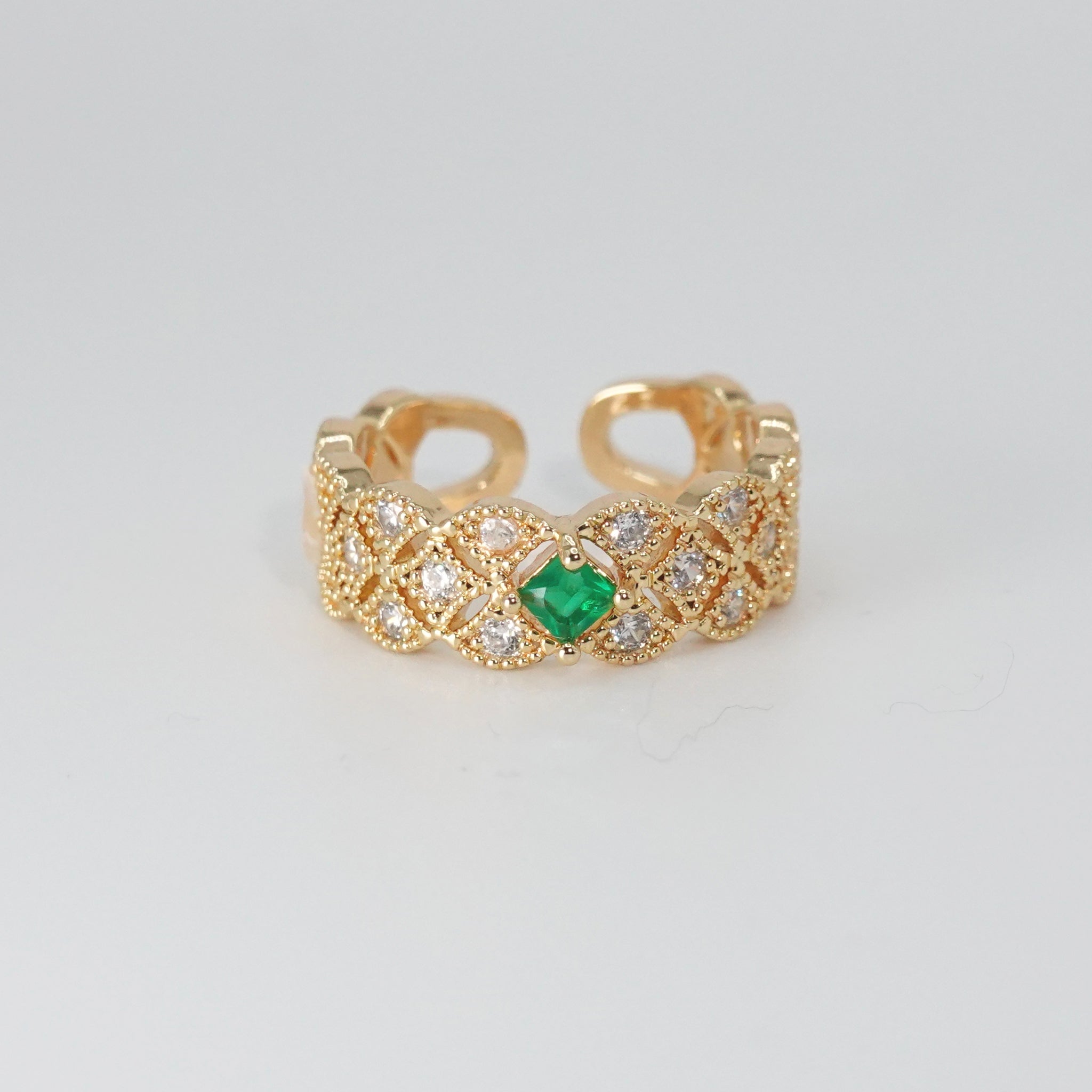 Jasmine Ring: Shimmering stones encircling a captivating green centerpiece, epitome of elegance.