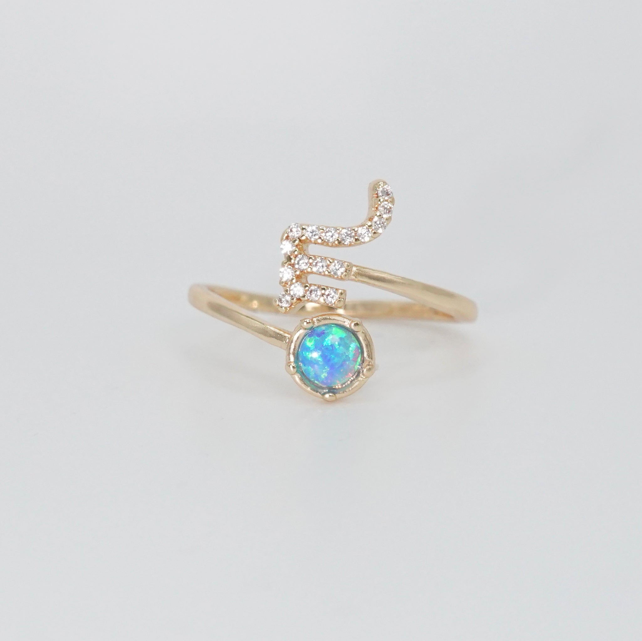 Scorpio Ring: Scorpion symbol with shimmering stones surrounding an opal, epitome of intensity.