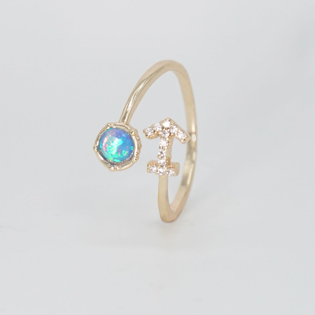 Sagittarius Ring: Archer symbol with shimmering stones surrounding an opal, epitome of adventure.