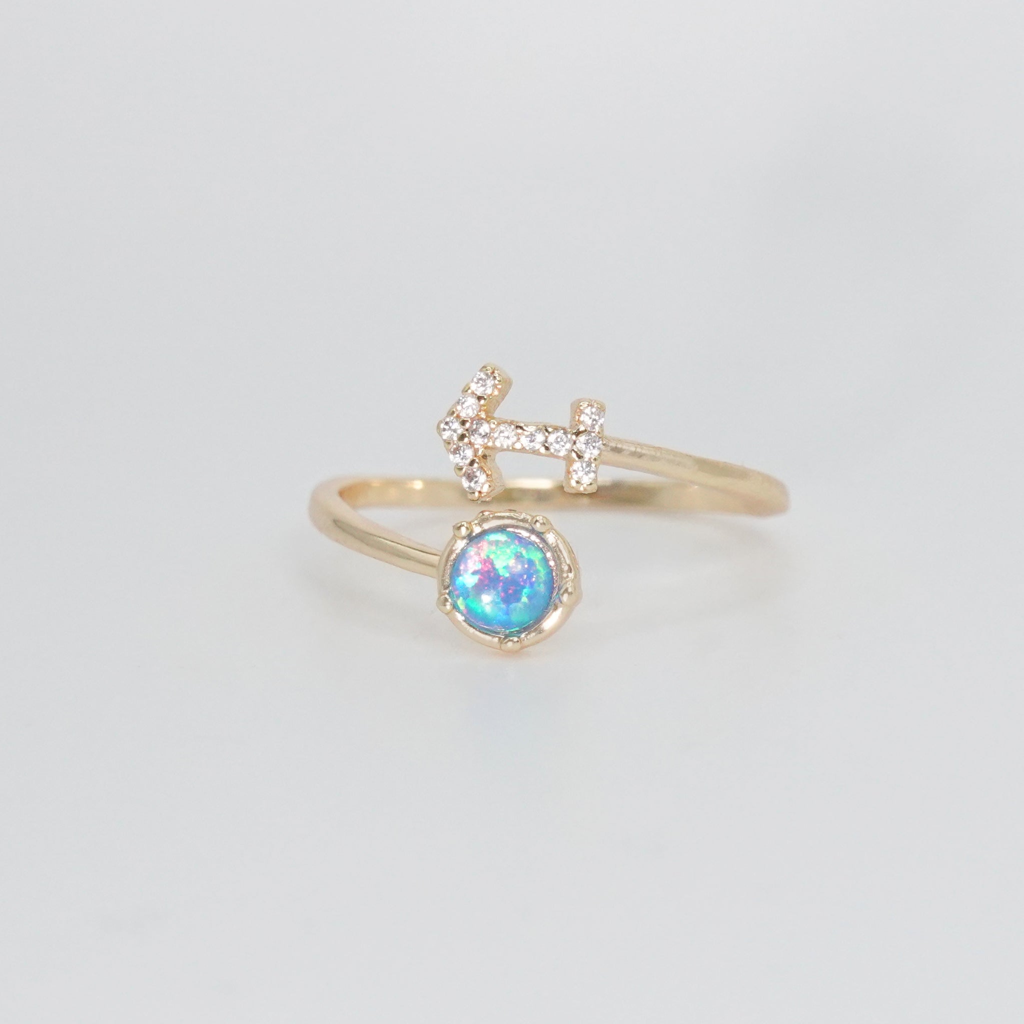 Sagittarius Ring: Archer symbol with shimmering stones surrounding an opal, epitome of adventure.