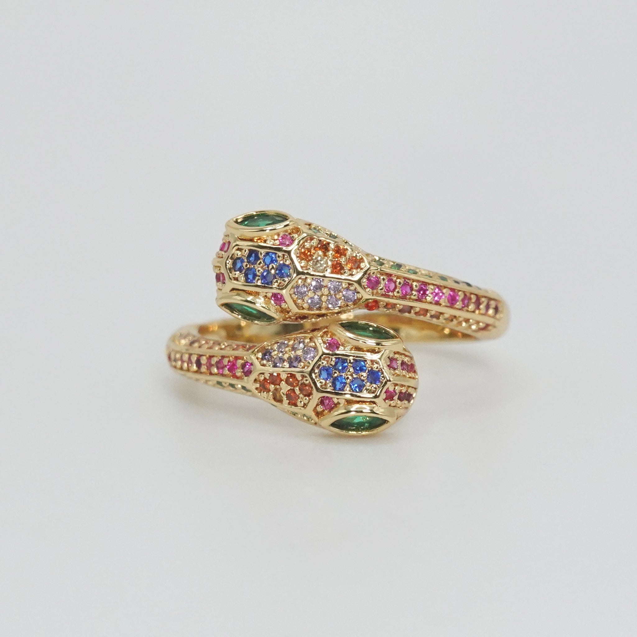 Twin serpents intertwined with shiny, colorful stones, exuding enchanting allure.
