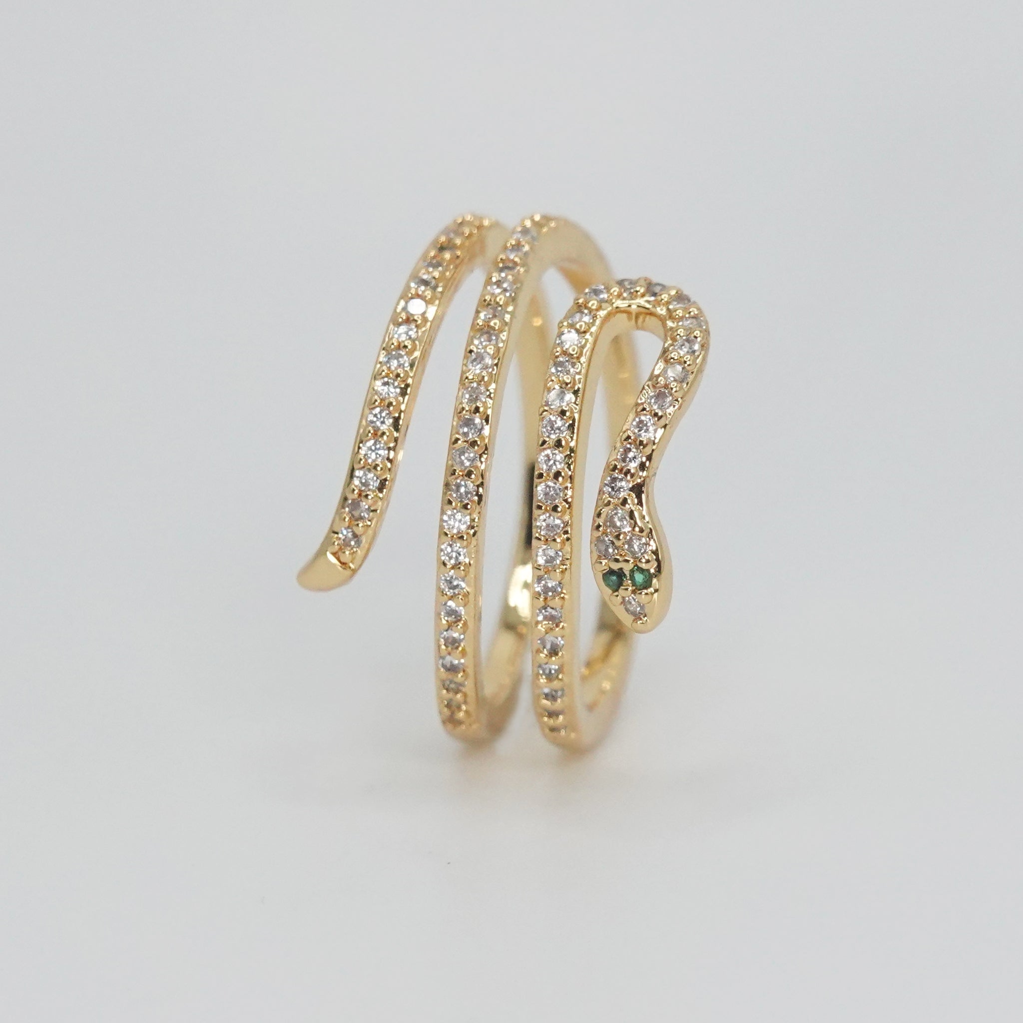 Rolling snake-shaped design with shimmering stones, epitome of elegance and mystique.