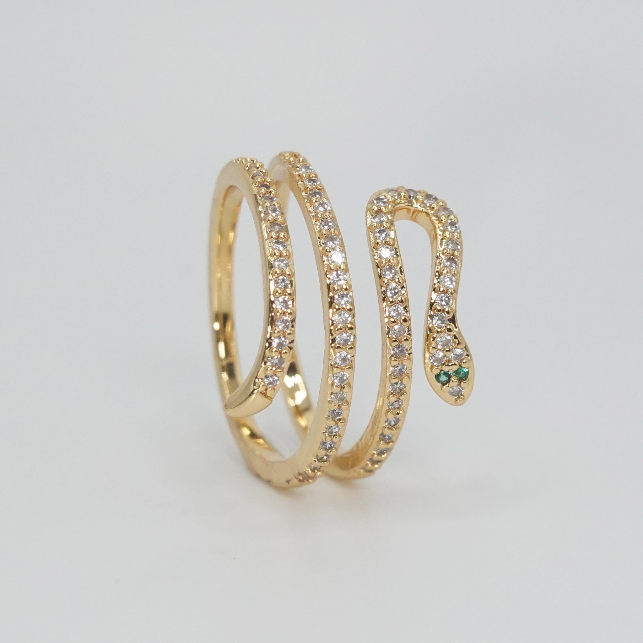 Rolling snake-shaped design with shimmering stones, epitome of elegance and mystique.