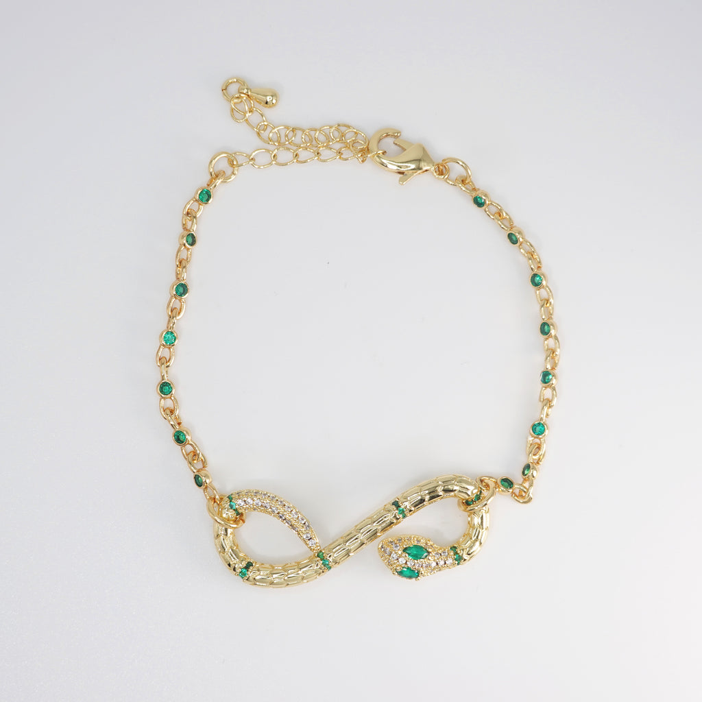 Violet Bracelet: Serpent-shaped design adorned with striking green stones, epitome of allure and sophistication.