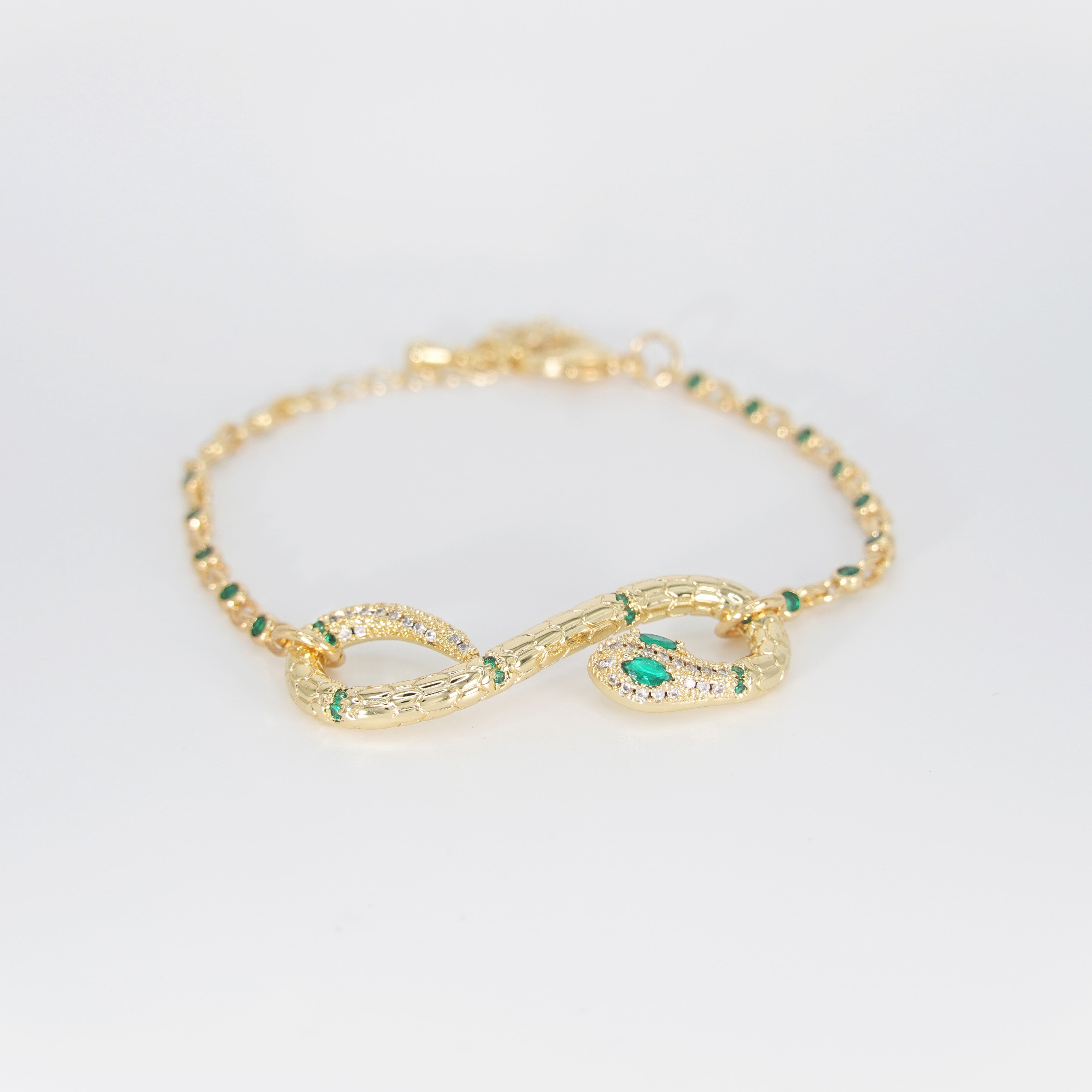Violet Bracelet: Serpent-shaped design adorned with striking green stones, epitome of allure and sophistication.