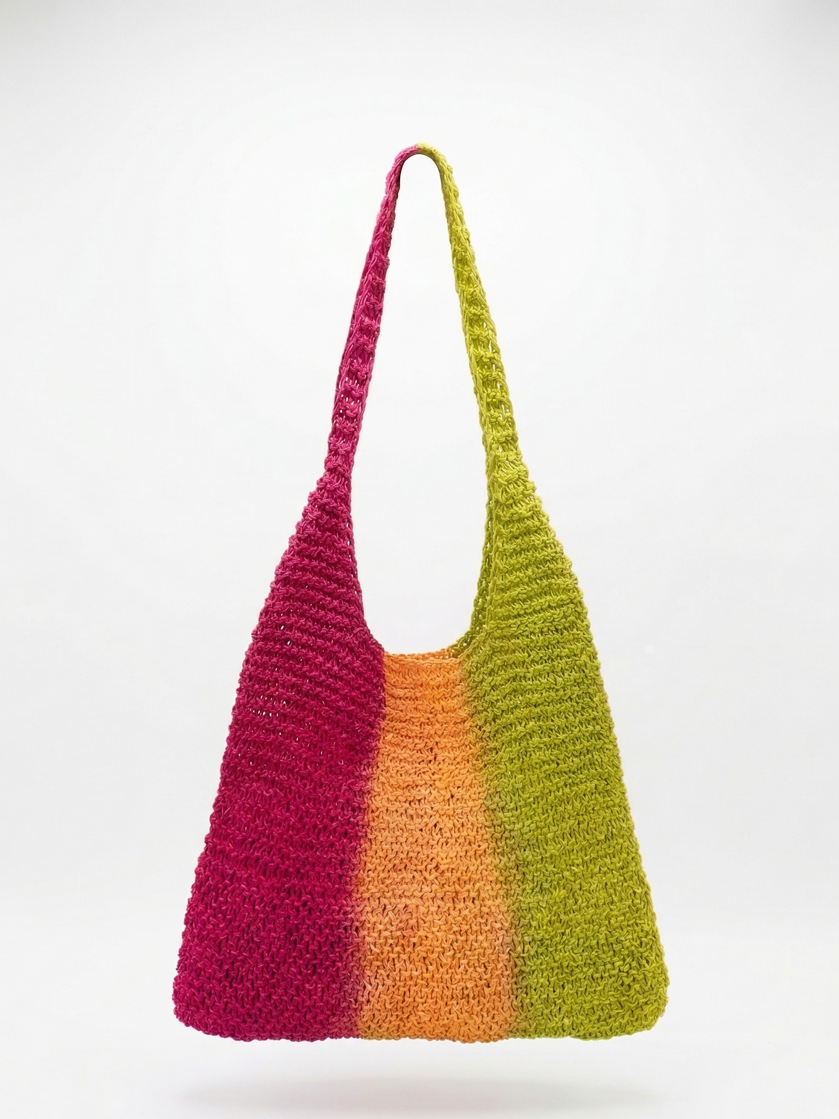 Colorful crocheted bag with a gradient from pink to green on a white background