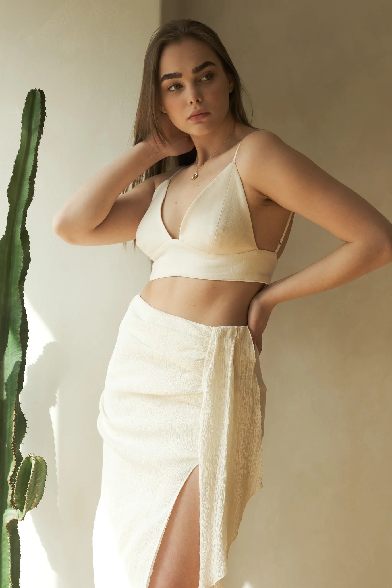 A woman wearing the Sundown Top, showcasing its relaxed fit, short sleeves, and flattering neckline, a versatile and stylish option for any occasion.