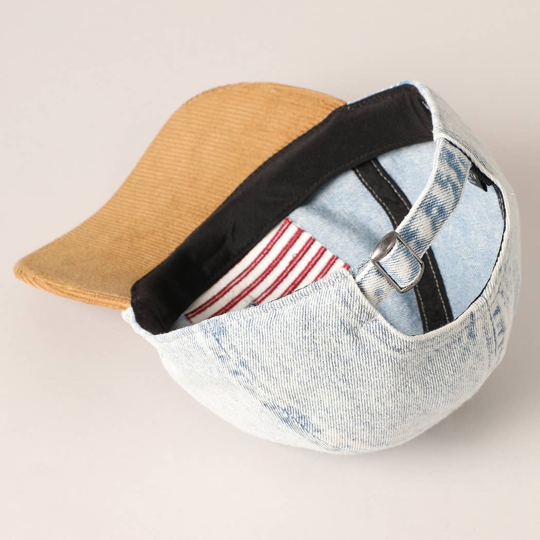 Cap with denim front and brown visor on a light beige background