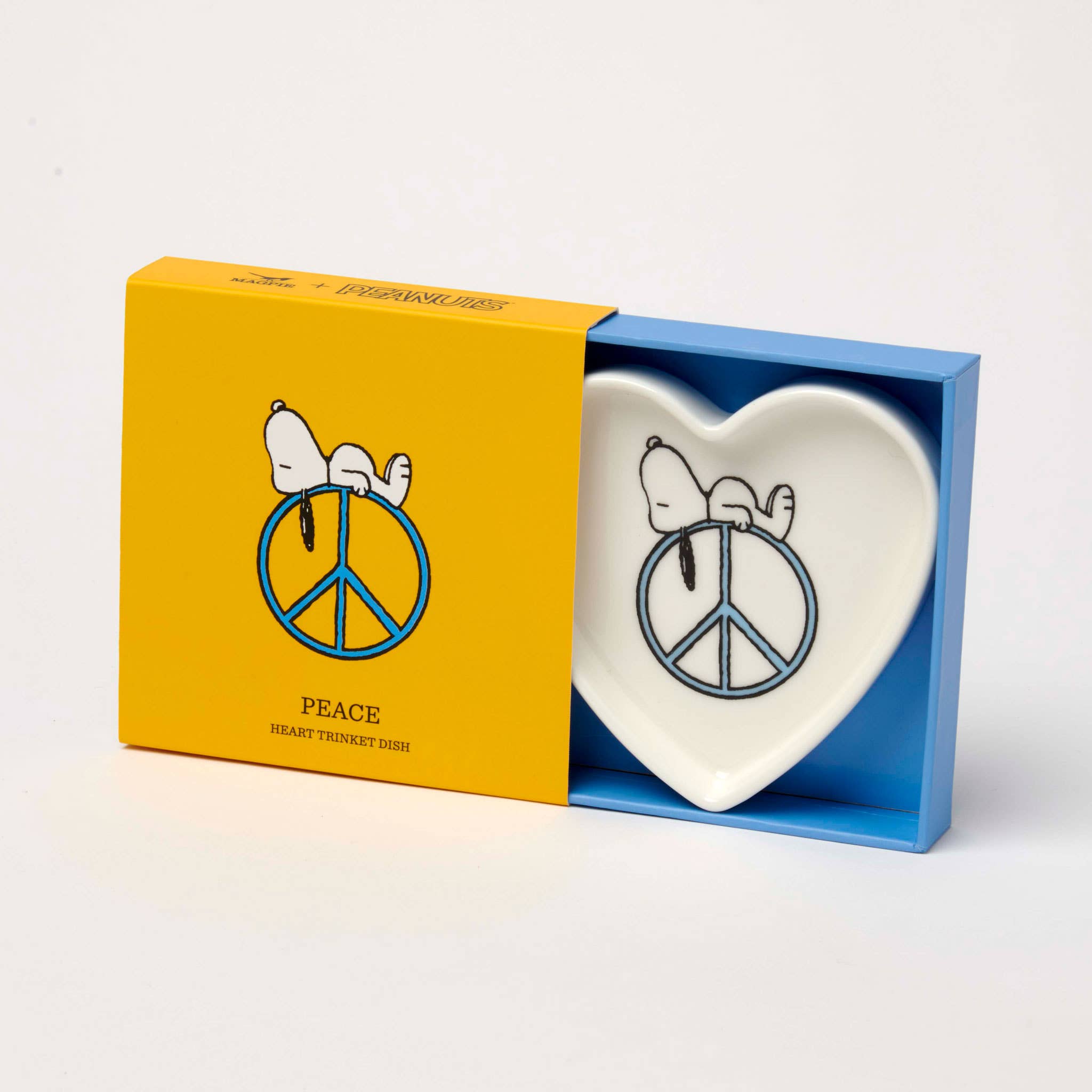 Heart-shaped trinket dish with Snoopy resting on a blue peace sign.