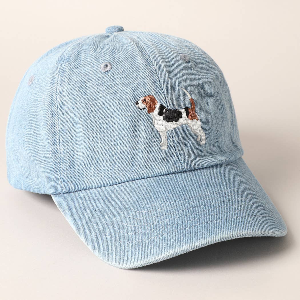 Light blue denim cap with a dog embroidery on a beige background