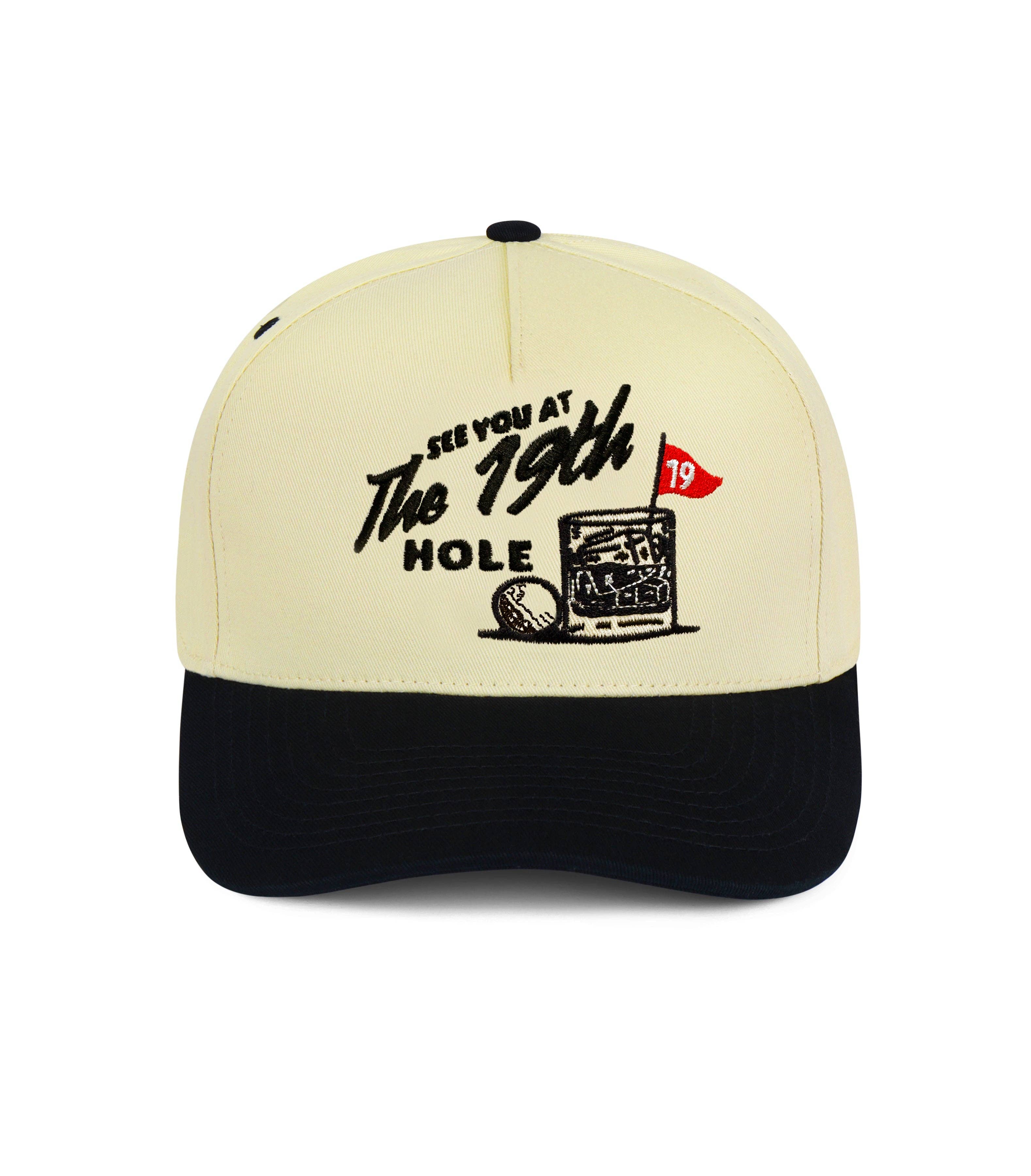 Beige and black cap with golf-themed design on a white background