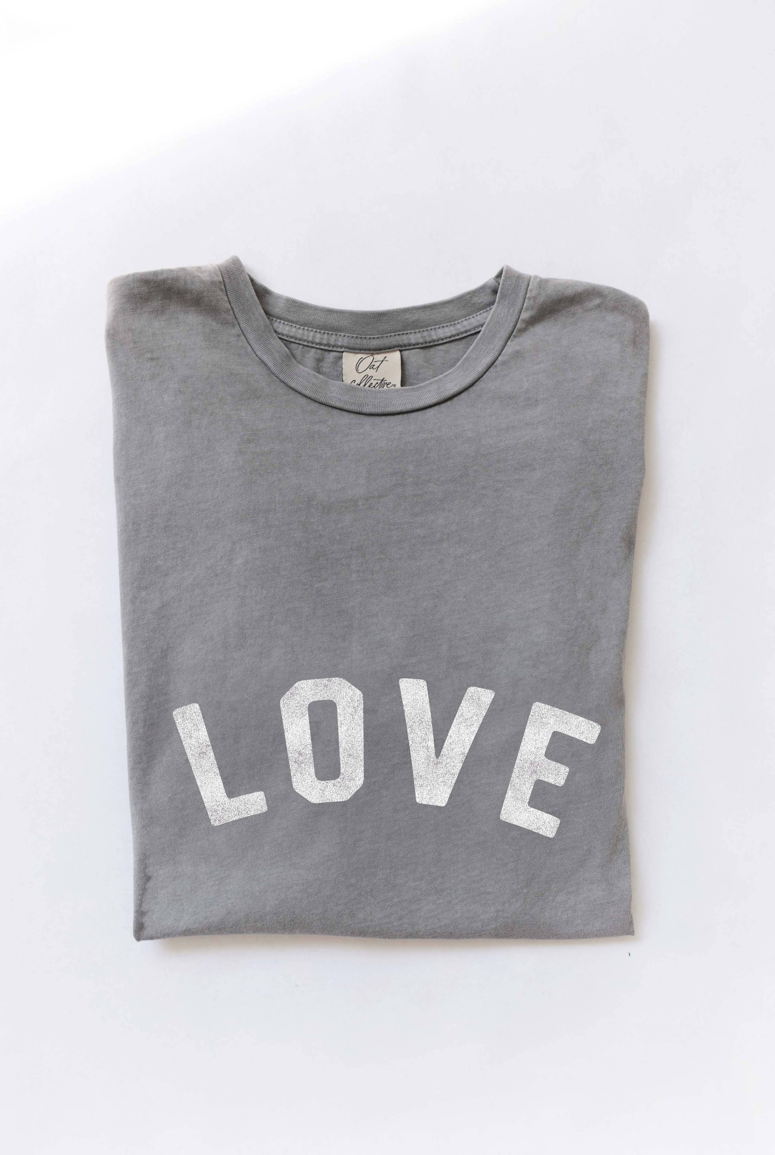 Ivory "LOVE" graphic t-shirt with bold red vintage-style lettering, made from soft cotton for a relaxed and comfortable fit.
