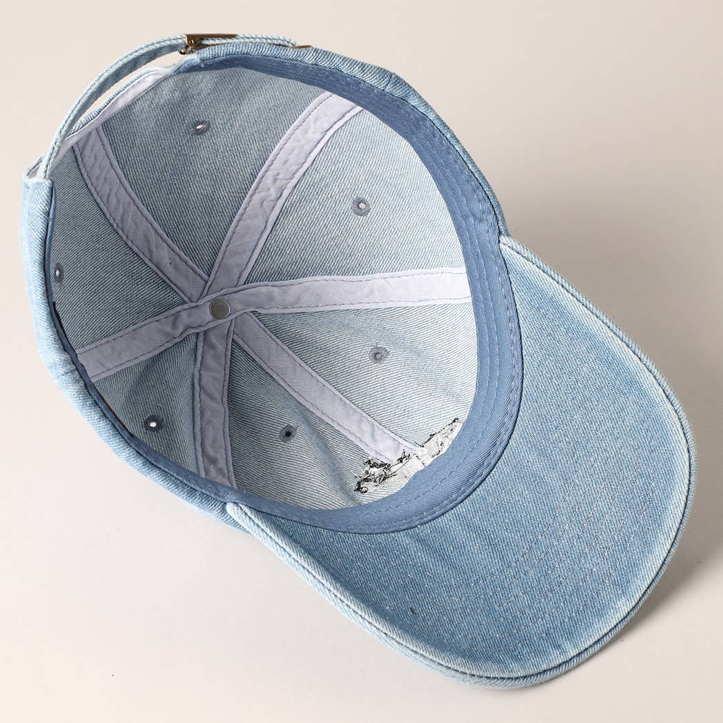 Light-wash denim baseball cap with embroidered black and white French Bulldog design.