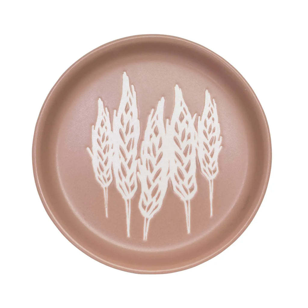 A coaster featuring a beautifully detailed wheat design.