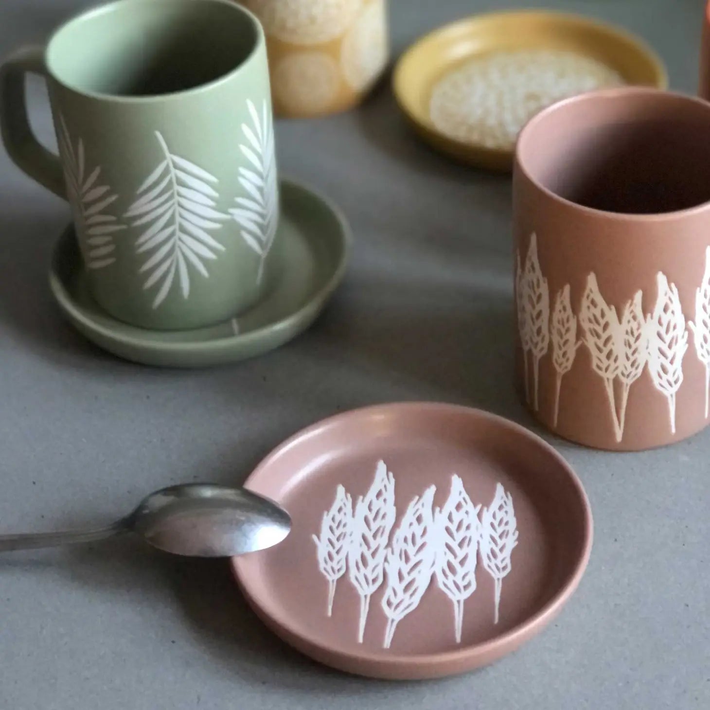 A coaster featuring a beautifully detailed wheat design.