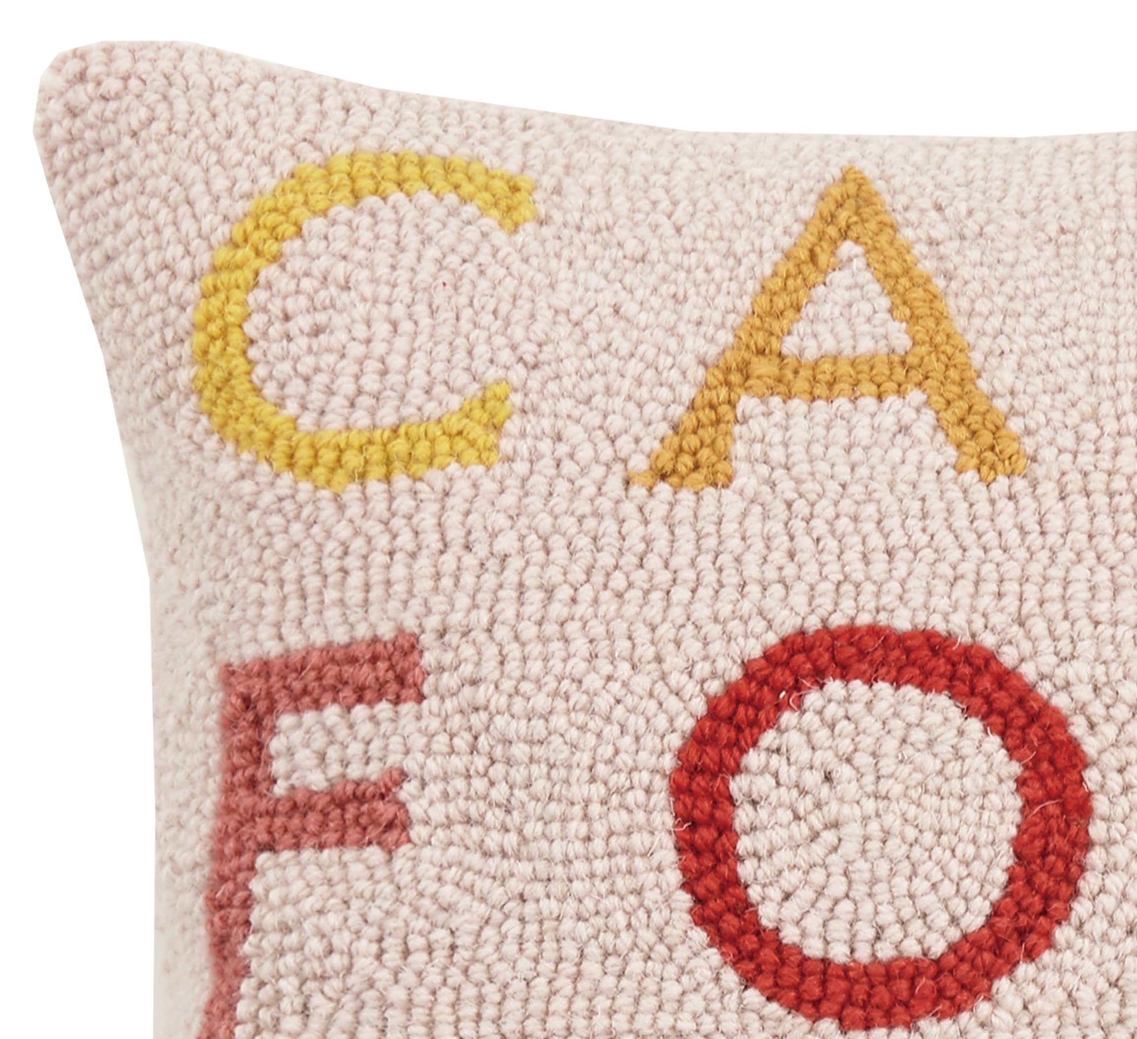 Square ivory hook pillow with multicolor block letters spelling "California" in a vertical layout.